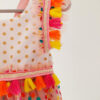 a close up a bright colour confetti spotted children's birthday party dress. This dress is handcrafted in New Zealand