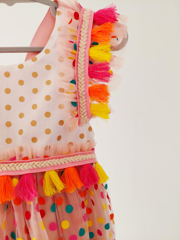 a close up a bright colour confetti spotted children's birthday party dress. This dress is handcrafted in New Zealand
