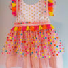 front view of a bright colour confetti spotted children's birthday party dress. This dress is handmade in New Zealand.