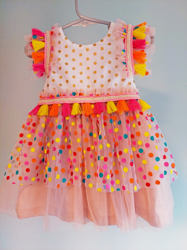 front view of a bright colour confetti spotted children's birthday party dress. This dress is handmade in New Zealand.