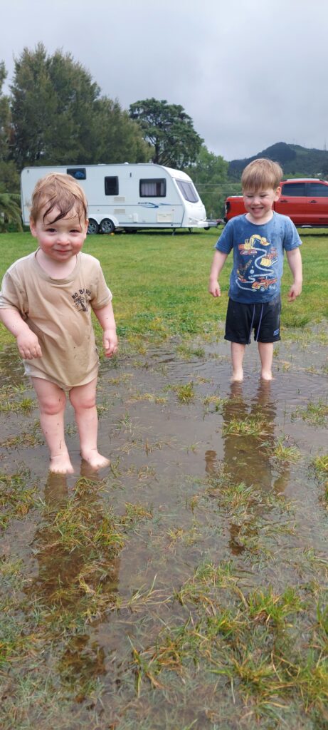 Owner of Mane and Tusk's two children getting muddy playing in a puddle.