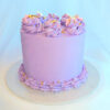 Custom celebration cake with three layers, finished in coloured Swiss meringue buttercream, piped decorations and sprinkles. Made in Cambridge, New Zealand.