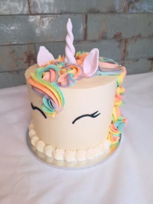 Unicorn birthday cake with rainbow mane and fondant horn from Mane and Tusk, Cambridge NZ