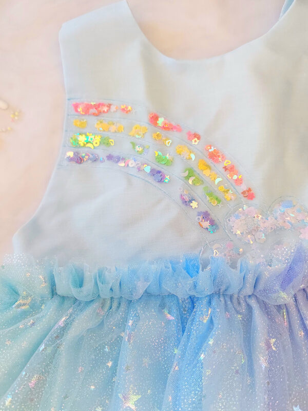 Pastel rainbow children’s occasion dress with sequin rainbow bodice and large rainbow bow at the back