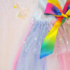 Pastel rainbow children’s occasion dress with sequin rainbow bodice and large rainbow bow at the back