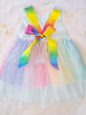 Pastel rainbow children’s occasion dress with sequin rainbow bodice and large rainbow bow at the back