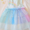 Pastel rainbow children’s occasion dress with sequin rainbow bodice and large rainbow bow at the back