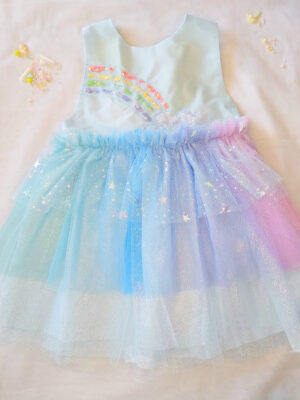 Pastel rainbow children’s occasion dress with sequin rainbow bodice and large rainbow bow at the back